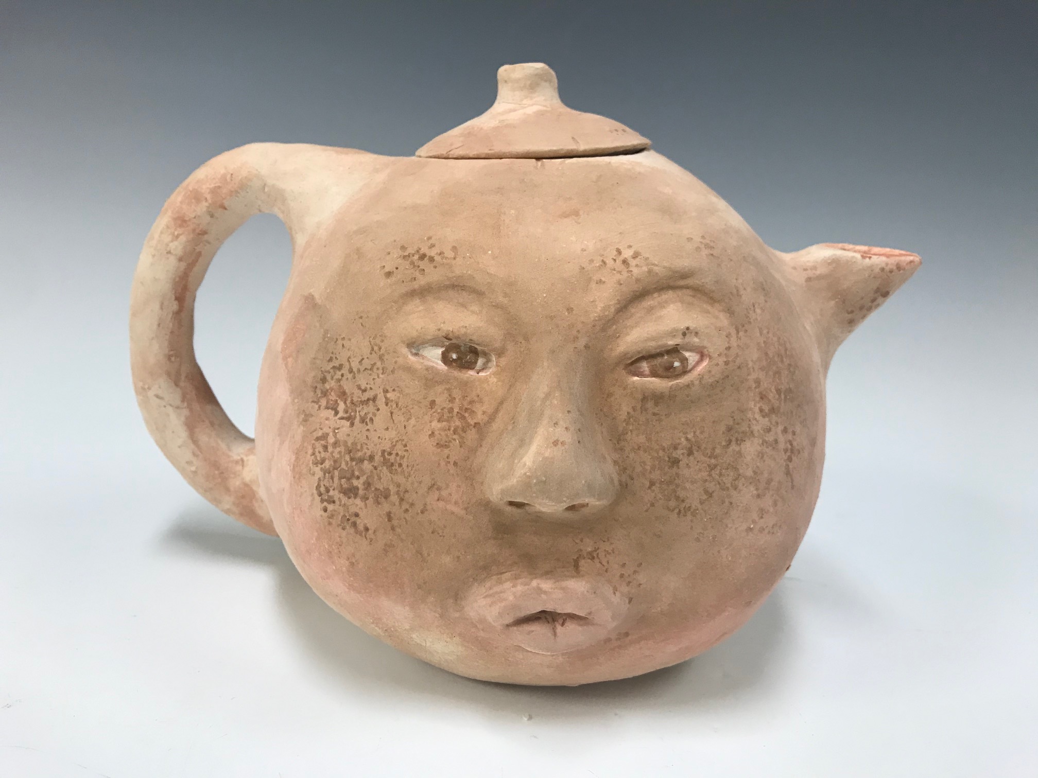 teapot with a human face