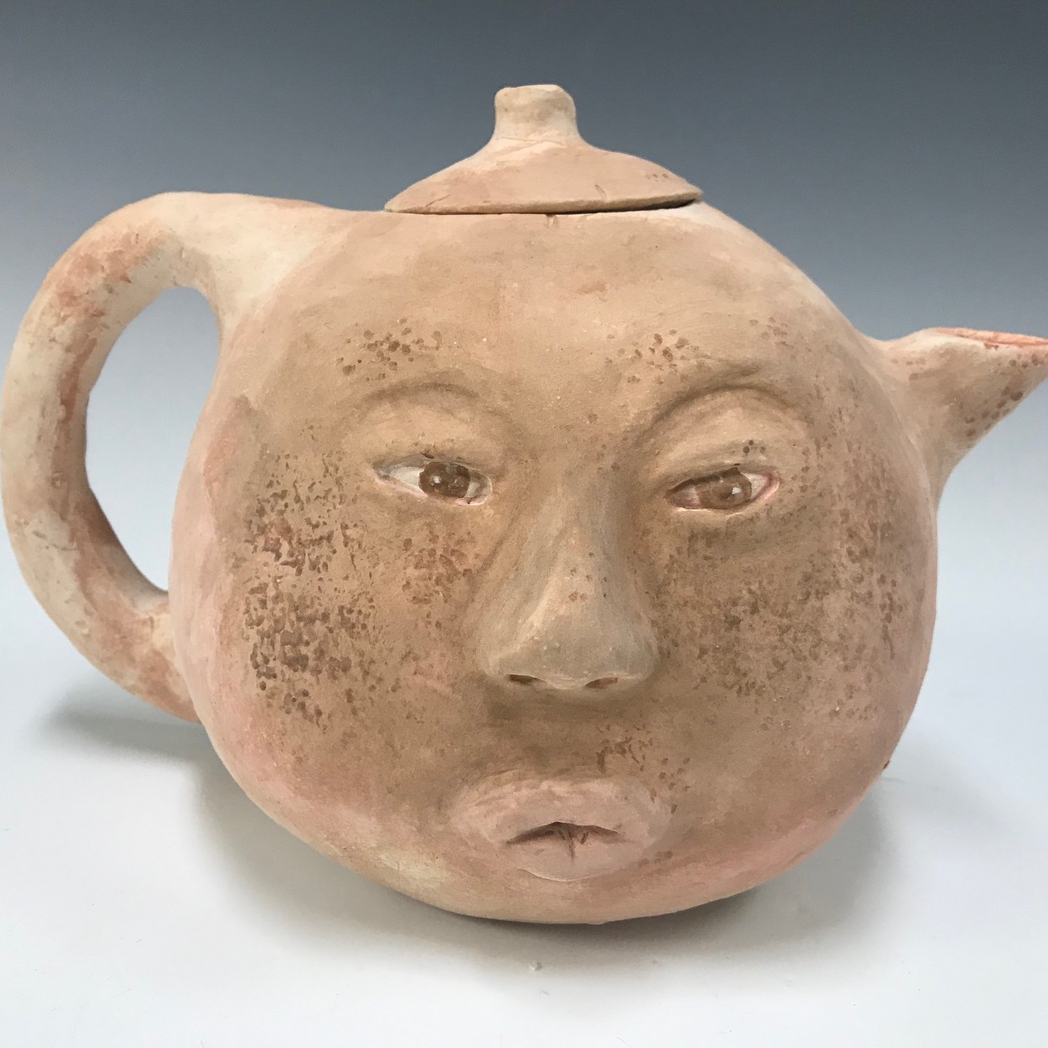 teapot with a human face